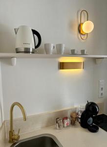 a kitchen sink with a coffee maker on a shelf at ÉPOCA in Santa Cruz de la Palma +3 photos