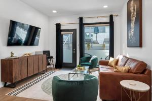 a living room with a couch and a table at UPSCALE Cozy Nashville Condo with POOL, PATIO, PARKING in Nashville