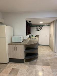a large kitchen with a counter and a refrigerator at Piscadera Bay Resort #16 in Dorp Sint Michiel