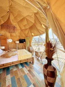 a bedroom with a bed in a tent with a vase at Boutique Citadel in Eforie Nord