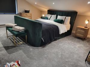 a bedroom with a large bed and a chair at TAI in Barry