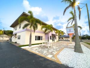 a building with palm trees in front of it at 2 Q Studio Apt With Shared Pool 03 in Clearwater