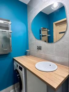 a bathroom with a sink and a mirror at BoleslaviaApartments - Apartament Simon 2, Center, air conditioning in Bolesławiec