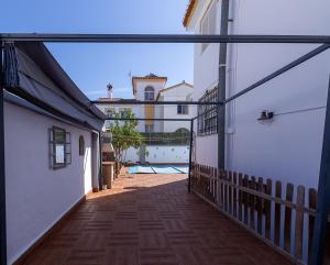 a balcony with a view of a swimming pool at Pregonero House in Granada