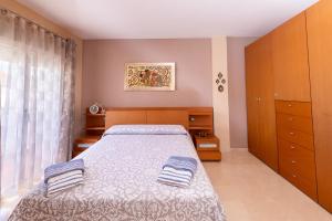 a bedroom with a bed with two towels on it at Pregonero House in Granada +26 photos