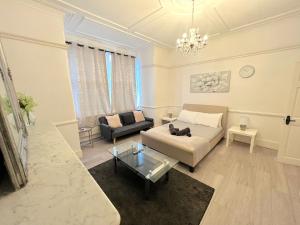 a living room with a couch and a table at Norbury House - Apartment 1A in Norbury