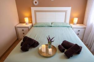 a bedroom with a bed with two candles on it at Blended in Calafell +47 photos