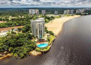 an aerial view of a building next to a beach at Hotel Tropical Executive Flat 918 in Manaus