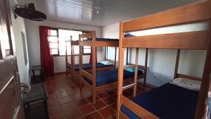 a room with three bunk beds in a house at Sobrado da Ruth in Guaratuba