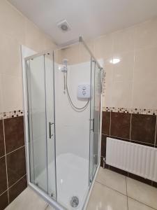 a shower with a glass door in a bathroom at Brielle House in Mountmellick