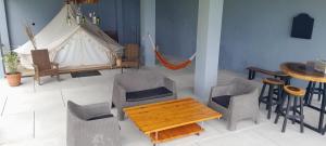 a room with a table and chairs and a tent at Refugio del Volcan Casitas in San Pedro La Laguna