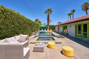 a backyard with a swimming pool with a couch and chairs at Pineapple Splash! Complete Privacy! Salt Pool! in Palm Springs