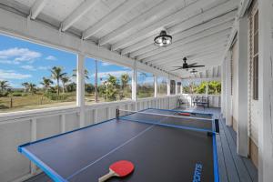 a ping pong room with a ping pong table at Villa Island Retreat, Country house overlooking 13 acres and a small lake in Saint James City