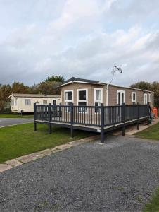 a mobile home with a porch and a fence at 136, Port Haverigg in Millom