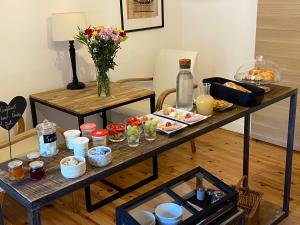 a breakfast table with food and drinks on it at MT.1937 in Condrieu