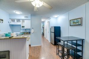 a kitchen with a counter and a table in a room at Corpus Christi Condo with Balcony and Beach Views! in Corpus Christi