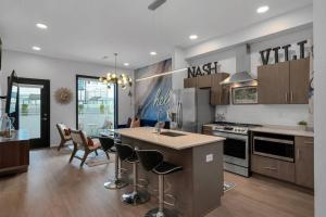 a kitchen with a sink and a stove top oven at Unique Nashville Condo with POOL, PATIO, PARKING in Nashville