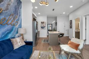 a living room with a blue couch and a desk at Unique Nashville Condo with POOL, PATIO, PARKING in Nashville