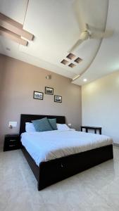 a bedroom with a large bed with a ceiling at Meera Valley Resort in Udaipur