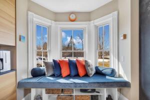 a window seat with pillows in front of a window at Sugar Maple Farm near Acadia - 4 Bedrooms, 5 Beds in Lamoine Corner