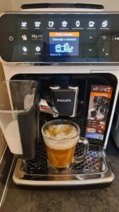 a coffee maker with a cup of coffee on a tray at Apartament Bogdan in Gura Humorului