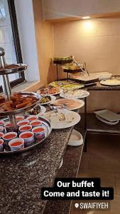 a buffet with plates of food on a counter at Al RAYAN HOTEL in Amman