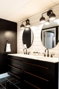 a bathroom with a sink and a mirror at Famous Music Row Presidential Suite 2 Bedroom, 2 Bathroom, 4 Beds in Nashville