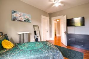 a bedroom with a bed and a flat screen tv at Cozy Roanoke Vacation Rental 2 Mi to Downtown! in Roanoke