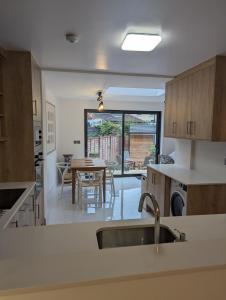 a kitchen with a table and a dining room at House in Barnes in London