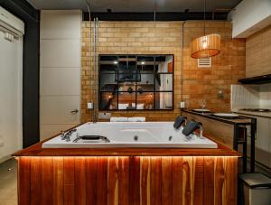 a kitchen with a bath tub in a kitchen at Hotel One Laureles in Medellín