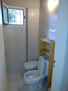 a small bathroom with a toilet and a window at CABAÑA MI PAZZ camino al cuadrado in Cordoba