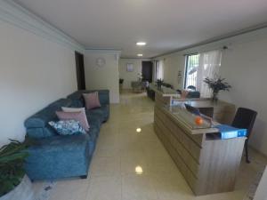 a living room with a couch and a table at CASA HOTEL FLOR DEL VALLE in Cali