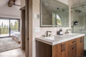 a bathroom with a sink and a mirror at Skylark Chalet in Big Sky