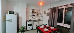 a small kitchen with a table and a refrigerator at Microcentro Monoambiente Vista in Buenos Aires