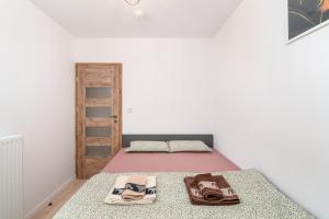a bedroom with a bed with a pink blanket at ApartWro 2th - City Square Railway Station, balcony, garage in Wrocław