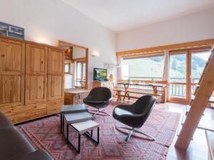 a living room with two chairs and a table at Studio Courchevel 1650, 1 pièce, 5 personnes - FR-1-563-31 in Courchevel