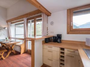 a kitchen with a counter and a table and windows at Studio Courchevel 1650, 1 pièce, 5 personnes - FR-1-563-31 in Courchevel