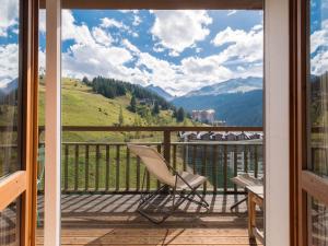 a chair on a balcony with a view of the mountains at Studio Courchevel 1650, 1 pièce, 5 personnes - FR-1-563-31 in Courchevel