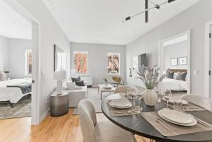 a dining room and living room with a table and chairs at Top Notch 2 Bedroom Minutes From Central Park in New York