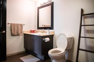 a bathroom with a toilet and a sink and a mirror at Oasis in heart of Hollywood in Los Angeles