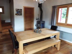 a dining room table with chairs and a wooden table at Chalet familial rénové 2 étoiles près du centre, 3 chambres, terrasse, parking, WiFi - FR-1-598-16 in Les Gets +6 photos