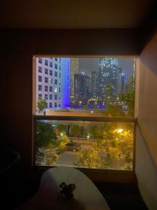 a window with a view of a city at night at Luxury 2BR with balcony in the heart of Dubai Marina, The Belvedere Happy Home in Dubai