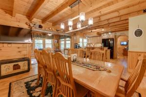 a dining room and kitchen with a large wooden table and chairs at Home with Indoor Spa 8 Mi to Smoky Mtn Natl Park! in Waynesville