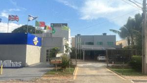 a building with flags on the side of it at Hotel Pousada Aeroporto in Goiânia