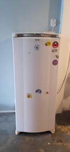 a white refrigerator with magnets on it in a room at Lapa Bed and breakfast Apartamento Rio de Janeiro in Rio de Janeiro