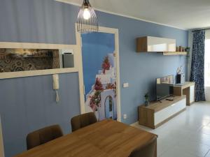 a dining room with a table and a blue wall at Team019 Sitges Richard España in Sant Pere de Ribes