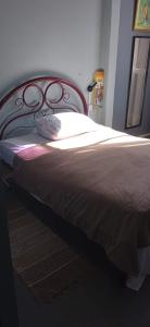 a bedroom with a large bed with a red frame at Lapa Bed and breakfast Apartamento Rio de Janeiro in Rio de Janeiro