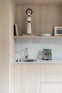 a kitchen counter with a sink and a book at ONTO Tonalá Mexico City in Mexico City