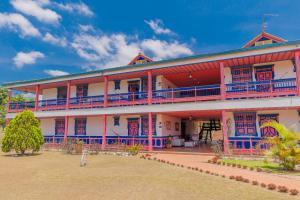 a large building with blue and red accents at Hotel Arrayanes del Quindío in Montenegro