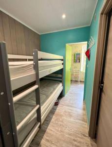 a room with bunk beds in a room with a hallway at Entre Montagnes et Lacs in La Bresse